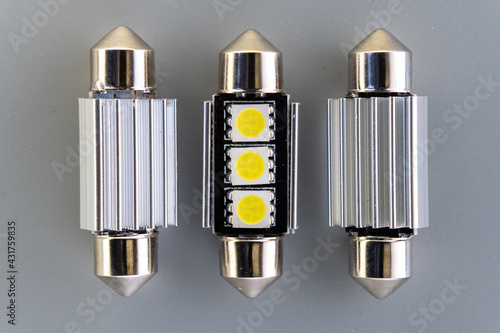 Car light bulb emitting diode, accessories and components for electronics vehicles. Modern technologies and low energy consumption concept. Gray background close-up view. 12V w5w photo