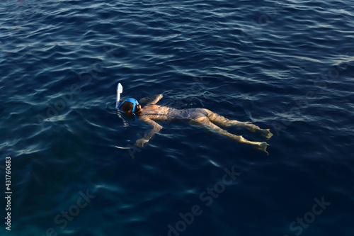young girl snorkeling in the blue sea. vacation concept