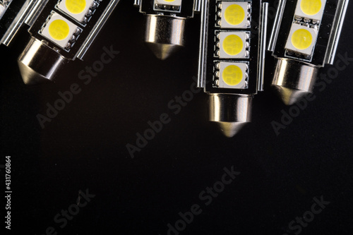 Lot of Car light bulbs emitting diode, accessories and components for electronics vehicles. Modern technologies and low energy consumption concept. Black background close-up view. 12V w5w photo