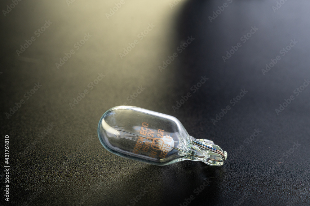 Ukraine, Khmelnytskyi - 4 may 2021: Bosh halogen bulb. Filament. Black background. Close-up view. copy space. w5w Ukraine, Khmelnytskyi - 4 may 2021: Bosh halogen bulb. Filament. Black background. Close-up view. copy space. w5w