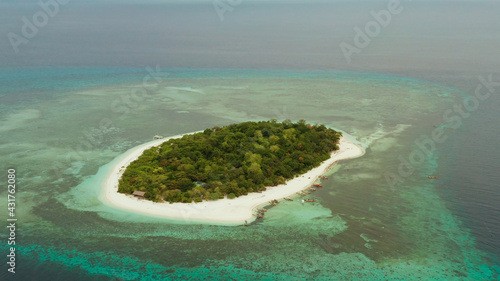 Tropical island Mantigue and sandy beach surrounded by atoll coral reef and blue sea, aerial view. Small island with sandy beach. Summer and travel vacation concept, Camiguin Philippines Mindanao