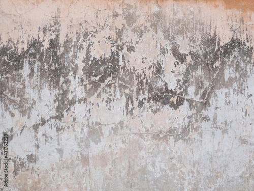 Peeling and cracked wall of an old house, grunge background