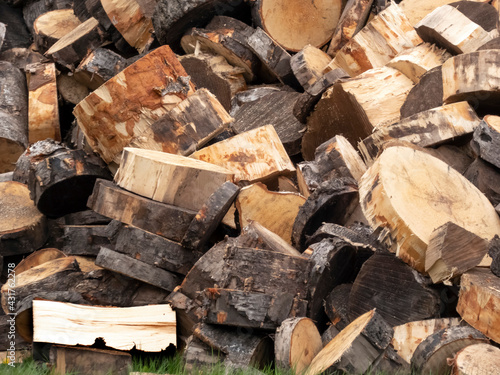 A pile of sawn pine firewood, natural wood texture
