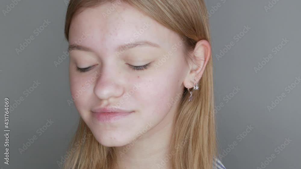 Beautiful young girl without makeup with a natural appearance posing in front of the camera in the studio Beautiful young girl without makeup with a natural appearance posing in front of the camera in the studio