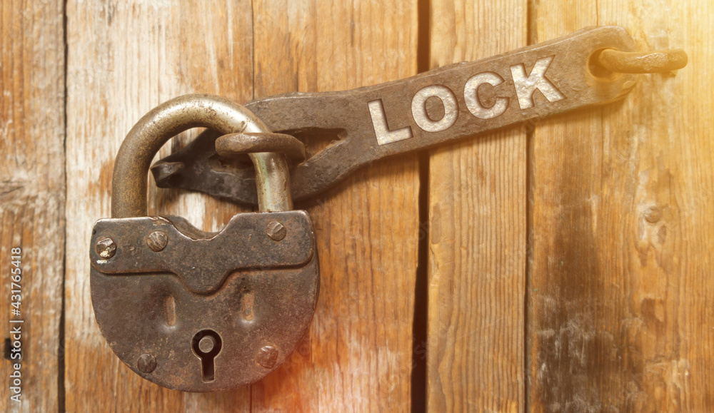 There is a lock on the door on the metal part of which it is written - LOCK There is a lock on the door on the metal part of which it is written - LOCK