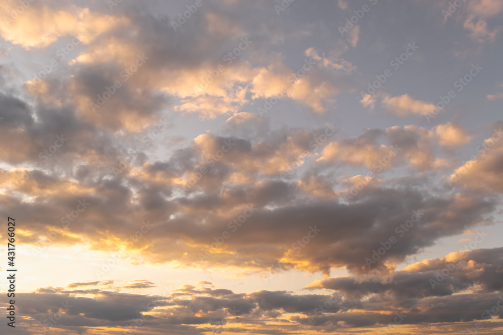 Clouds in the sky in the evening at the hour of sunset, beautifully illuminated by rays. Beautiful airy background. Place for your text. Horizontal photo. Clouds in the sky in the evening at the hour of sunset, beautifully illuminated by rays. Beautiful airy background. Place for your text. Horizontal photo.