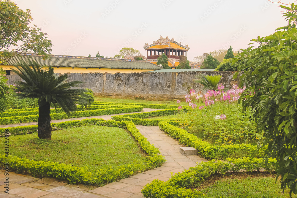 Manicured gardens at the ancient imperial city citadel and palace grounds of Hue, a historic landmark in Vietnam.