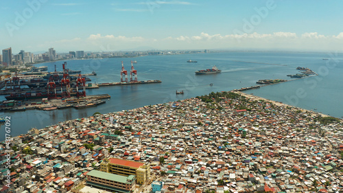 Poor district and slums with shacks in a densely populated area of Manila aerial view.