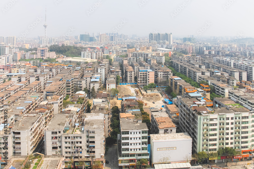 Aerial cityscape skyline view of urban sprawl with air pollution and smog in Huadu District suburb of Baiyun Guangzhou, China.