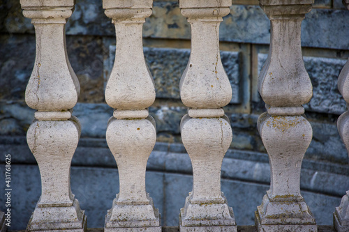 Antique marble pillars hold the railing. Decorative element of the railing in the castle, marble balusters.