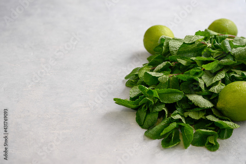 Fresh aromatic mint and juicy lime on a light background