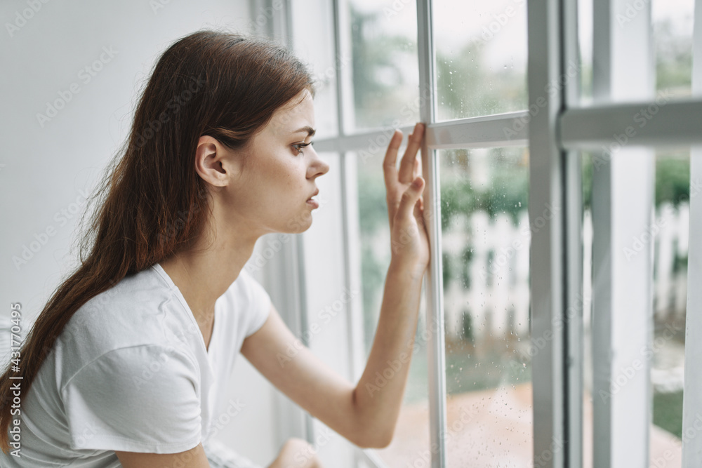 woman looking out the window pensive look emotions sadness woman looking out the window pensive look emotions sadness