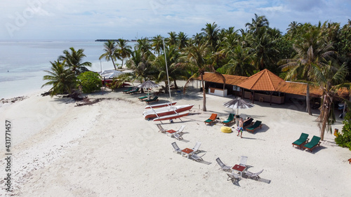 Maldives resort island drone aerial view  Indian ocean atoll nature beach and palm forest  leisure tourist luxury vacation
