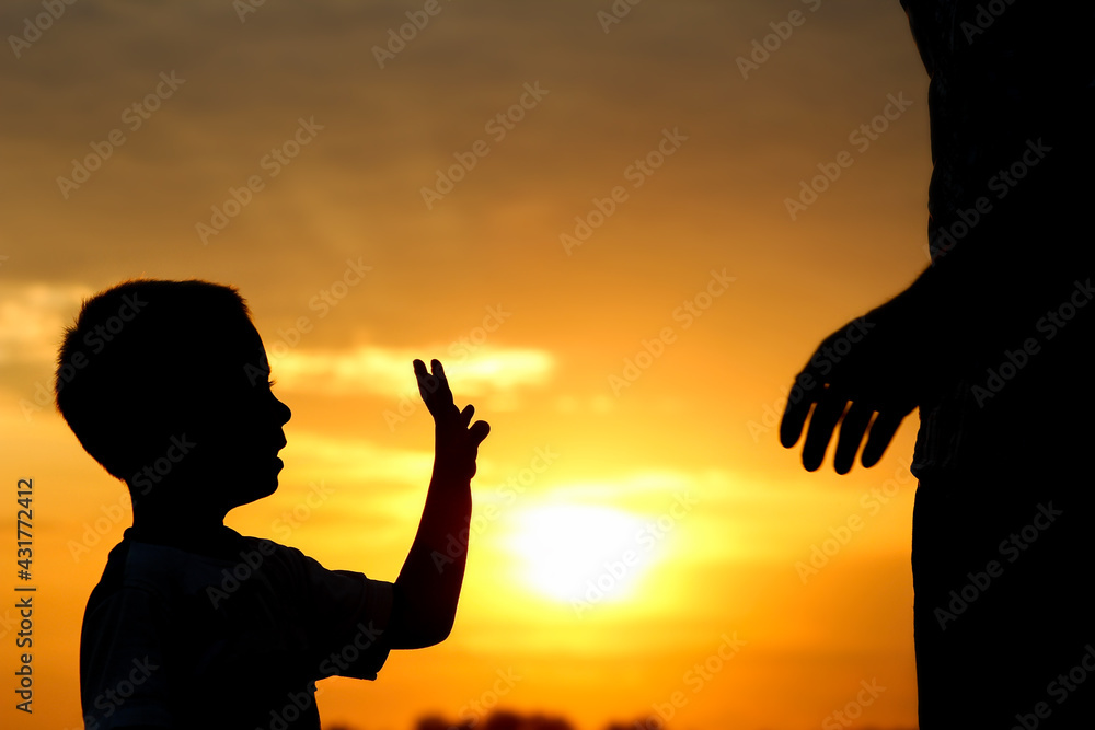 happy dad with a child in the park outdoors silhouette