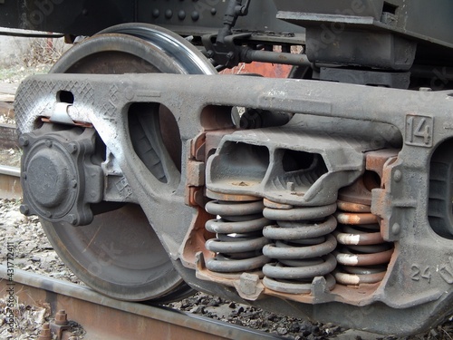 Wheeled trolley of a freight train. Cargo train wheels close-up.