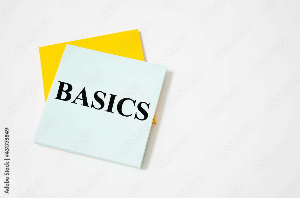BASIC text written on a white notepad with colored pencils and a yellow background. word BASIC text written on a white notepad with colored pencils and a yellow background. word