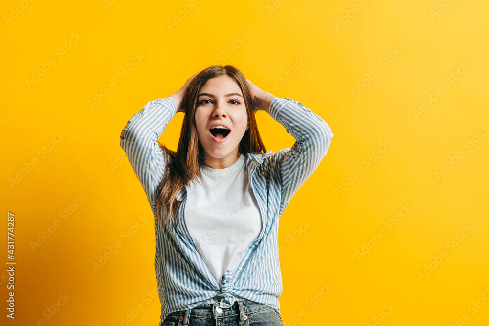 Portrait of excited young woman surprised by something expresses shock and surprise, isolated on yellow background with copy space. Portrait of excited young woman surprised by something expresses shock and surprise, isolated on yellow background with copy space.