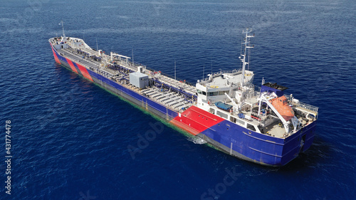 Aerial drone photo of crude oil tanker carrier anchored in deep blue open ocean sea © aerial-drone