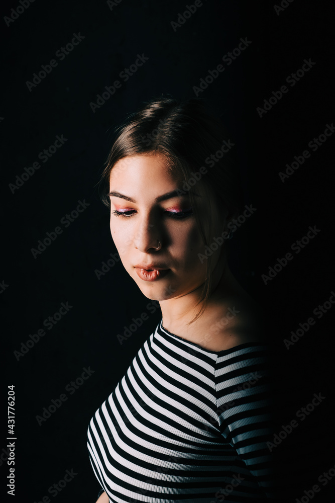 Portrait of attractive woman in with brunette hair on black background in studio. Portrait of attractive woman in with brunette hair on black background in studio.