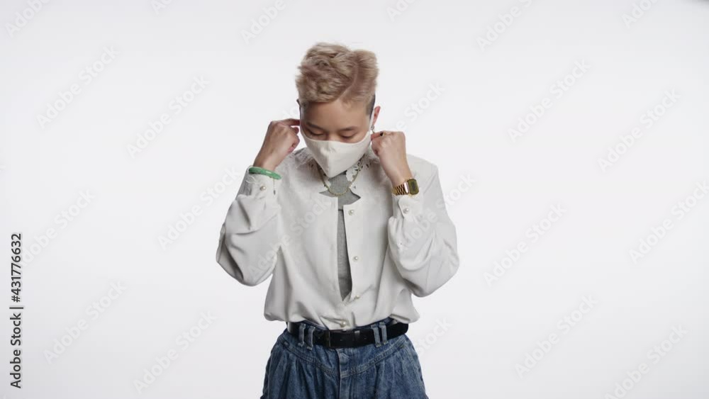 Handsome Asian person removes mask and takes a deep breath Handsome Asian person removes mask and takes a deep breath
