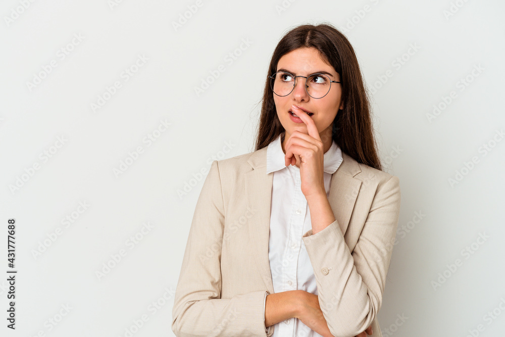 Young business caucasian woman isolated on white background relaxed thinking about something looking at a copy space. Young business caucasian woman isolated on white background relaxed thinking about something looking at a copy space.