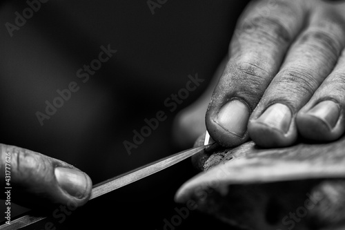 Goldsmith's hands at work, handmade jewelery photo