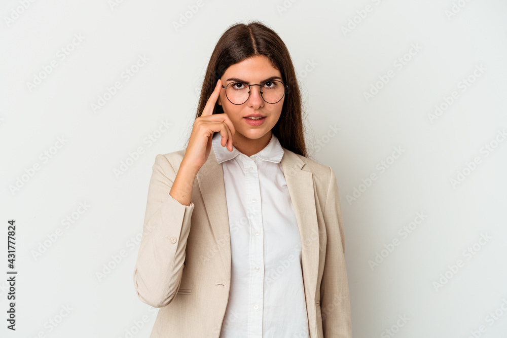 Young business caucasian woman isolated on white background pointing temple with finger, thinking, focused on a task. Young business caucasian woman isolated on white background pointing temple with finger, thinking, focused on a task.