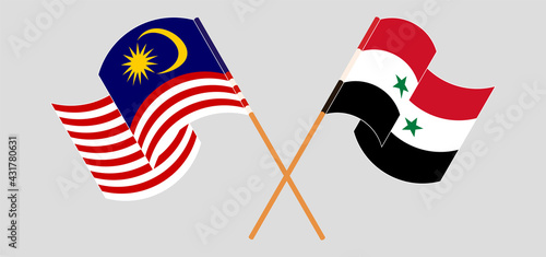 Crossed and waving flags of Malaysia and Syria