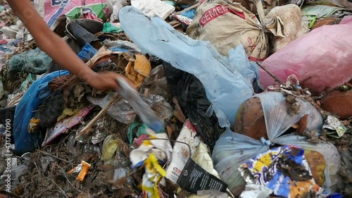 Hand Poor Kid Collects Bottle To Recycle On A Garbage Dump
 photo