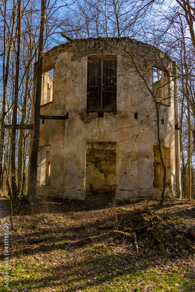 The ruin of a circular building between trees with fallen leaves, Czech republic.