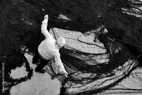 fisherman works fishing net for tuna