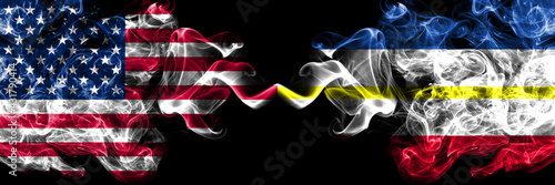 United States of America  America  US  USA  American vs Germany Mecklenburg  Western Pomerania smoky mystic flags placed side by side. Thick colored silky abstract smoke flags.