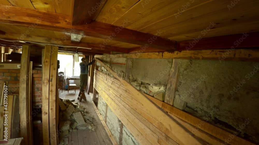 Worker dismantle and demolish the old wooden house. 4K. Worker dismantle and demolish the old wooden house. 4K.