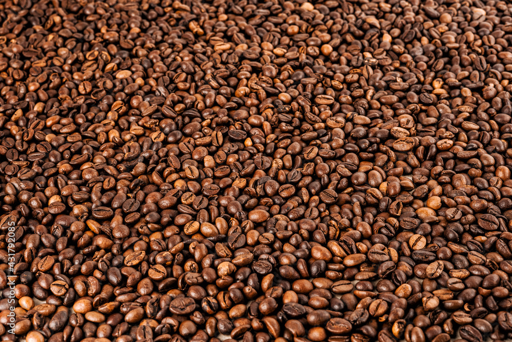 Coffee beans. Coffee beans are spread out on the surface.