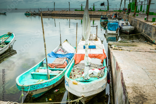 Two colorful Mexican panga fishing boats docked in the harbor along the Melecon, Campeche, Mexico. © Compass Studios