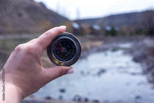 compass in man hand nature background