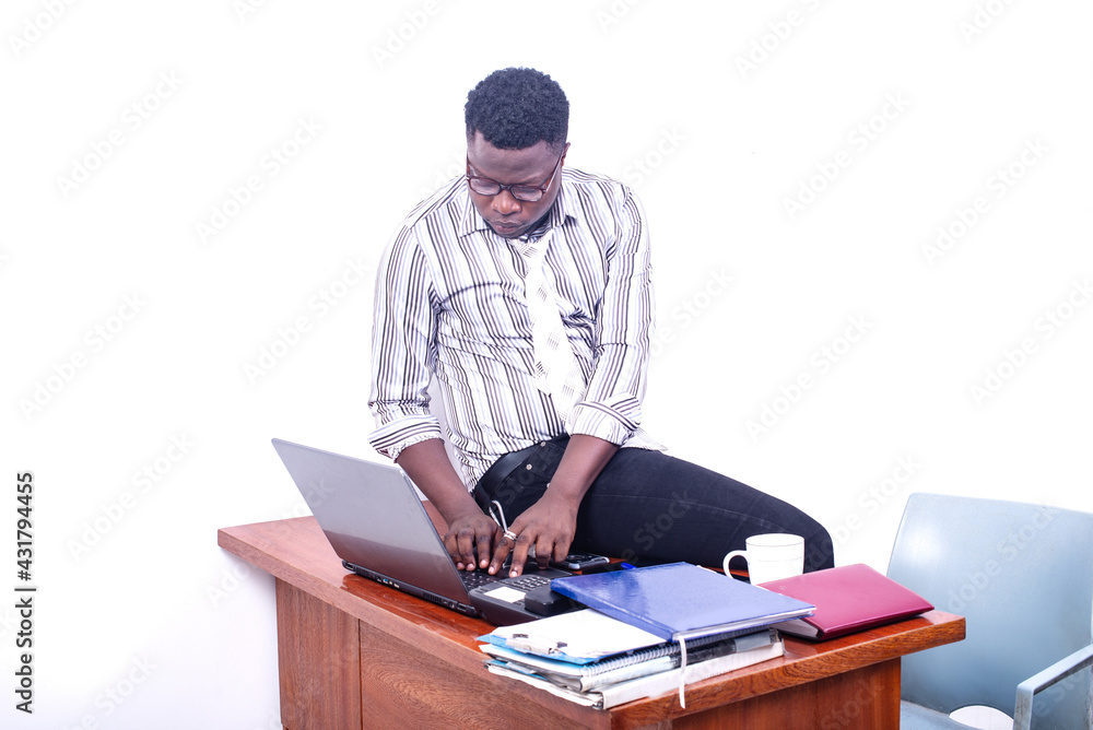 young serious businessman working on laptop in office. young serious businessman working on laptop in office.