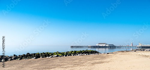 Clacton Beach and Pier from the North side panoramic view in springtime sunlight photo