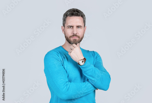 handsome mature man with beard on grey background with wristwatch, accessory