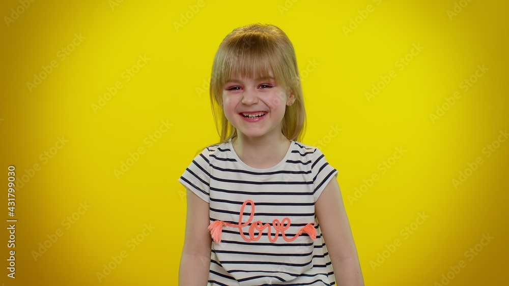 Smiling blonde kid child in t-shirt laughing out loud after hearing ridiculous anecdote, funny joke, feeling carefree amused, positive people lifestyle on yellow background. Teenager children girl Smiling blonde kid child in t-shirt laughing out loud after hearing ridiculous anecdote, funny joke, feeling carefree amused, positive people lifestyle on yellow background. Teenager children girl