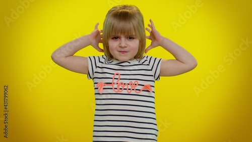 Dissatisfied blonde child girl 5-6 years old asking reason of failure, expressing disbelief irritation, feeling bored, disappointed in result, bad news on yellow studio background. Teen kid children