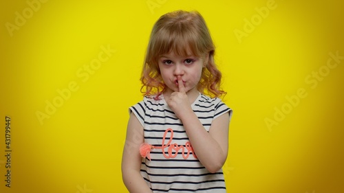 I will not say anyone. Funny little blonde teen kid child girl closing her mouth with hand, looking intimidated scared at camera, gestures no, refusing to tell terrible secret, unbelievable truth