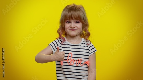 I am the best. Proud egoistic blonde kid child satisfied of her victory, bragging own success win achievements, pointing with smile fingers on herself. Teenager children girl on yellow wall background