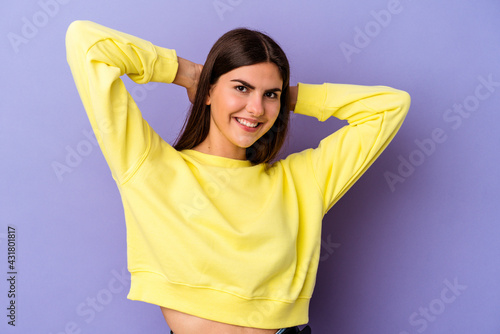 Young caucasian woman isolated on purple background feeling confident, with hands behind the head.
