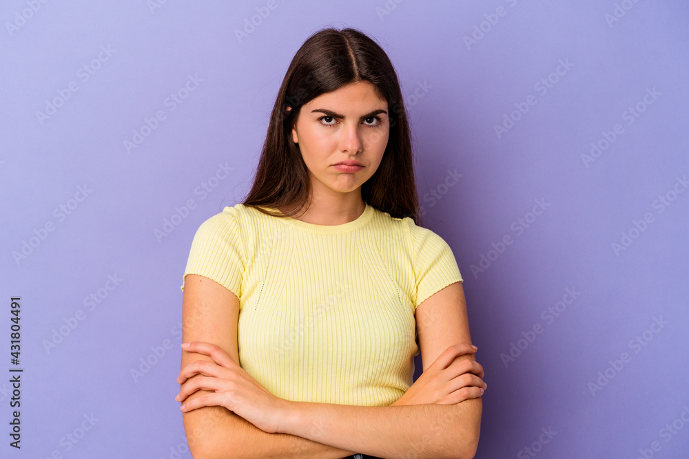 Young caucasian woman isolated on purple background blows cheeks, has tired expression. Facial expression concept. Young caucasian woman isolated on purple background blows cheeks, has tired expression. Facial expression concept.