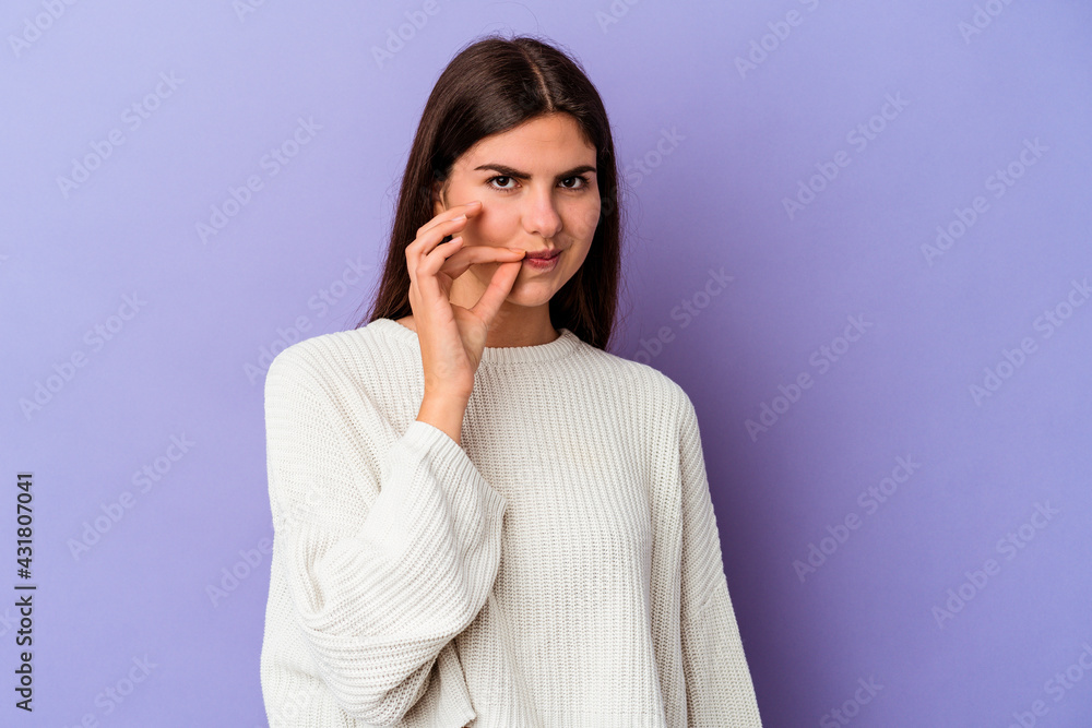 Young caucasian woman isolated on purple background with fingers on lips keeping a secret. Young caucasian woman isolated on purple background with fingers on lips keeping a secret.