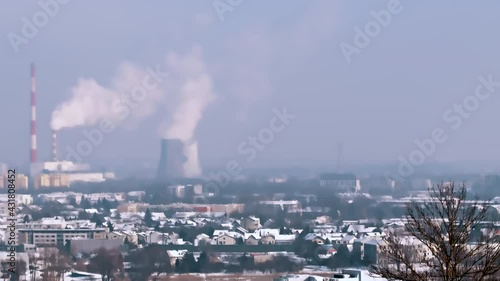Panoramic view of the City skyline. View of Krakow from Krakus Mound. The industrial site of the city. Smoke rises from the pipes of the thermal Power plant polluting the clear blue sky.