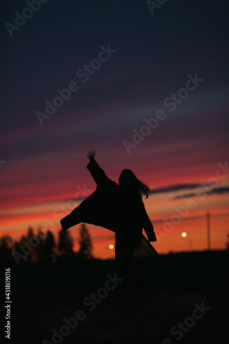 Silhouette of a girl after sunset.