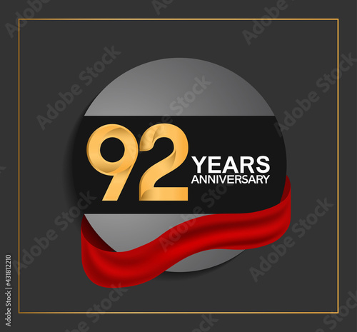 Fototapeta Naklejka Na Ścianę i Meble -  92 years anniversary logotype with golden color and red ribbon on black circle with glitter background isolated on black background. can be use for celebration and party