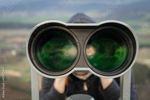 Fotografie young man watching with a binocular,
tactical spying outdoors